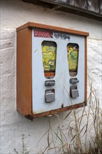 Chewing gum vending machine from the 1950s on a house wall, Franconia, Bavaria, Germany, Europe