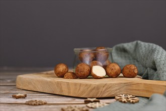 L German Christmas sweets called 'Marzipankartoffeln'. Round ball shaped almond paste pieces