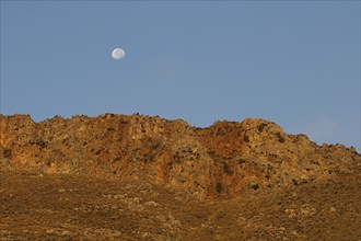 Golden morning light, moon over mountain range, Gramvoussa peninsula, Pirate Bay, Balos, Tigani,