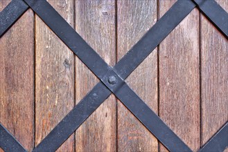 Weathered wood background with iron bars and brown colored planks