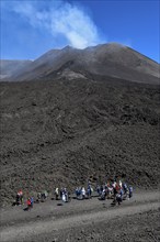 Hikers in the crater landscape of the volcano Etna, summit region, province of Catania, Sicily,