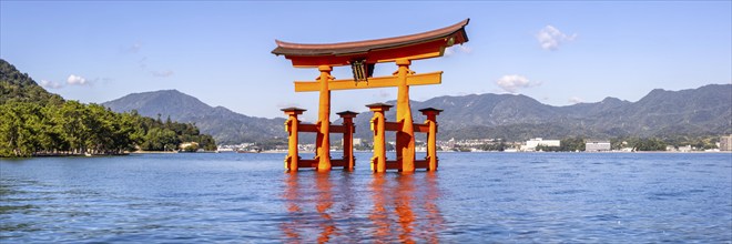 Famous red wooden torii gate UNESCO World Heritage Site Panorama on Miyajima Island, Japan, Asia