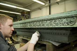 Restorer at Fuchs&Gierke, here a metal sarcophagus from a family vault is expertly cleaned and