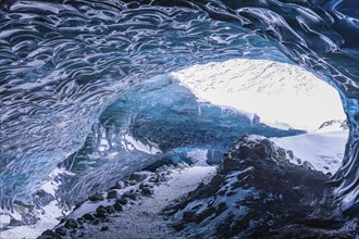 Aquamarine-coloured ice combs at the entrance to Pröng Ice Cave, Sudurland, Iceland, Europe