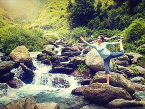 Yoga outdoors, woman doing yoga asana Natarajasana, Lord of the dance balance pose outdoors at