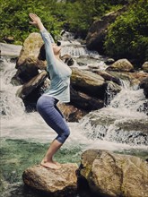 Vintage retro effect hipster style image of sporty fit woman doing yoga asana Utkatasana (chair