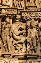 Stone carving bas relief sculptures on Vaman Temple, Khajuraho, Madhya Pradesh, India, Asia