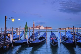 Romantic vacation Venice travel background, gondolas at Saint Mark (San Marco) square and Basilica