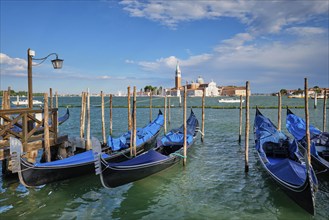 Gondolas and in lagoon of Venice by Saint Mark (San Marco) square with San Giorgio di Maggiore