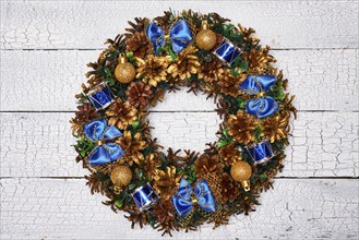 Christmas wreath on white painted wooden background