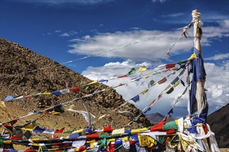 Buddhist prayer flags lungta on Namshang La pass in Himalayas. Ladakh, India, Asia