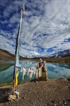 Small gompa with buddhist prayer flags at sacred Dhankar Lake. Spiti Valley, Himachal Pradesh,