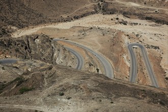 Serpentine road on the way to Yemen, landscape of southern Dhofar, Jabal al-Qamar, Oman, Asia