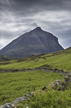 Old dry stone wall in front of mountain top Sàil Gharb, one Quinag's three separate Corbett summits