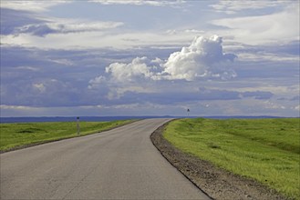 Empty road and rain clouds forming over the Gobi desert, rain shadow desert turning green in