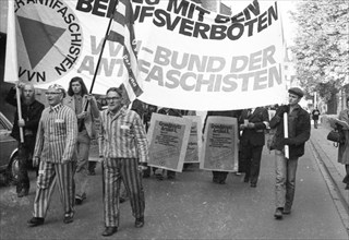 Nazi victims, some in concentration camp uniforms, demonstrated against the occupational bans