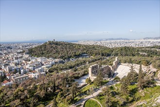 View from the Acropolis of Herod's Theatre and Philopappos Hill, behind sea of houses of the city,