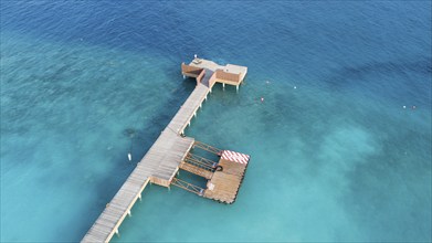 Aerial view bird's eye view of jetty of Maldives Island of Maldives, in foreground jetty for