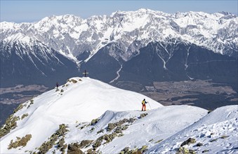 View of the Inn Valley, ski tourers at the summit of the Pirchkogel, mountains in winter,