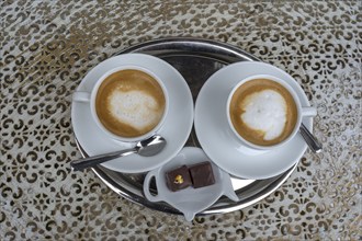 Two cappuccinos on a bistro table, Bavaria, Germany, Europe