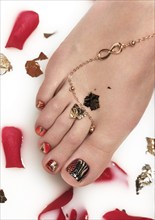 An original pedicure on female feet. Creative nail art design