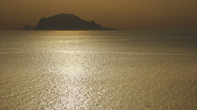 Santa Marina Salina, sunrise, sun rises behind Panarea, Panarea island near, light reflections on