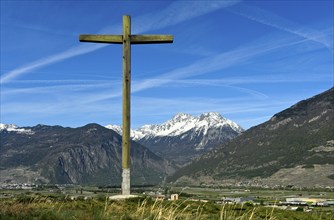 Wooden cross visible from afar on a hill above the Rhone valley in Lower Valais, Charrat, Valais,