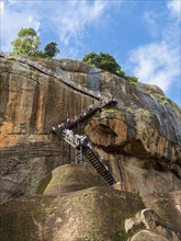 Visitors climb the stairs at Sigiriya Rock, Sri Lanka, Asia