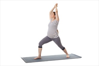 Pregnancy yoga exercise, pregnant woman doing asana virabhadrasana 1, warrior pose isolated on