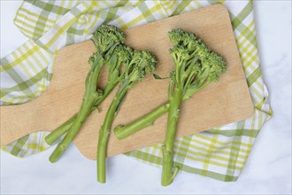 Bimi, broccolini, asparagus broccoli on wooden board