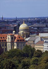 The tambour dome of the New Synagogue covered in gilded ribs in the city panorama, Berlin, Germany,