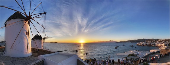 MYKONOS, GREECE, MAY 29, 2019: Panorama of traditional greek windmills on Mykonos island on sunset