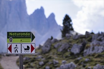 Mass tourism, sign separating paths for hikers and families with prams, Stone City, Sella Pass,