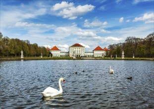 Swan in fountain in Grand Parterre (Baroque garden) and the rear view of the Nymphenburg Palace.