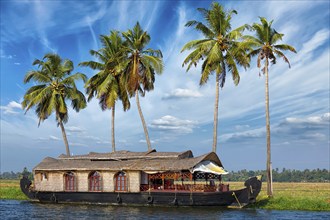 Kerala travel tourism background, houseboat on Kerala backwaters. Kerala, India, Asia