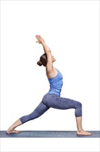 Beautiful sporty fit yogini woman practices yoga asana Virabhadrasana 1, warrior pose 1 isolated on