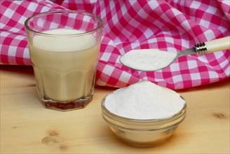 Glass of milk and bowl with lactose, lactose, sugar