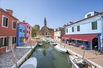 Colourful houses on the canal with reflection, canal with boats and colourful house facades, in the