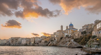 View of the village with the Greek Orthodox church of Agios Nikolaos, Asteria Beach, at sunset with