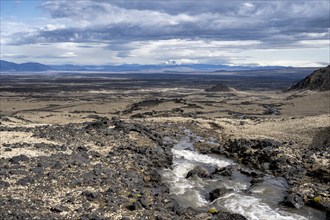 River flows through volcanic landscape, volcanic rocks and tuff, barren landscape, Vatnajökull