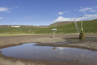 Shower and sink with hot water at Krafla, volcanic caldera in the Myvatn Geothermal Area in summer,