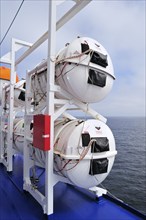 Inflatable life rafts in hard-shell canisters on board a ferry boat