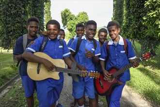 Pupils of the Catholic mission station of Vunapope in school uniforms and with guitars, Kokopo,