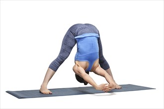 Beautiful sporty fit woman practices Ashtanga Vinyasa yoga asana Prasarita padottanasana C, wide