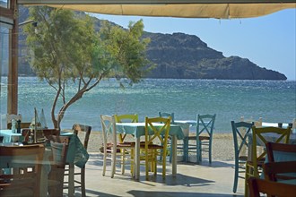 Gastronomy, colourful tables and chairs on the beach, Plakias, Crete, Greece, Europe