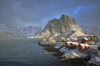 Hamnoy fishing village on Lofoten Islands, Norway with red rorbu houses. With falling snow blizzard