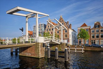 Gravestenenbrug bridge on Spaarne river and old houses in Haarlem, Netherlands