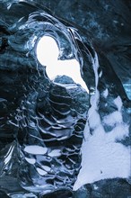 Ice cave open to the top with snow-covered ice combs, Pröng ice cave, Sudurland, Iceland, Europe