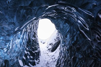 Ice cave open to the top with snow-covered ice combs, Pröng ice cave, Sudurland, Iceland, Europe