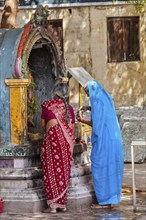 MADURAI, INDIA, FEBRUARY 16, 2013: Unidentified Indian women worship Hindu god Ganesh in famous